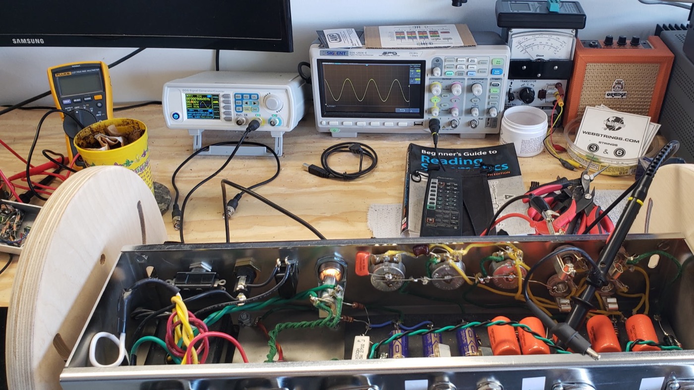 Amp chassis on the test bench alongside scope and signal generator