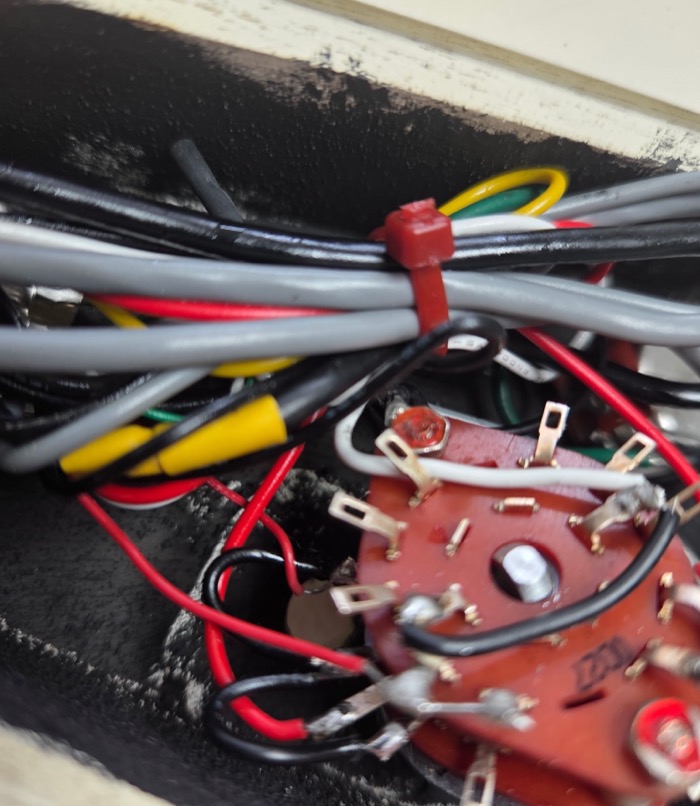 Wiring harness routed above a switch assembly